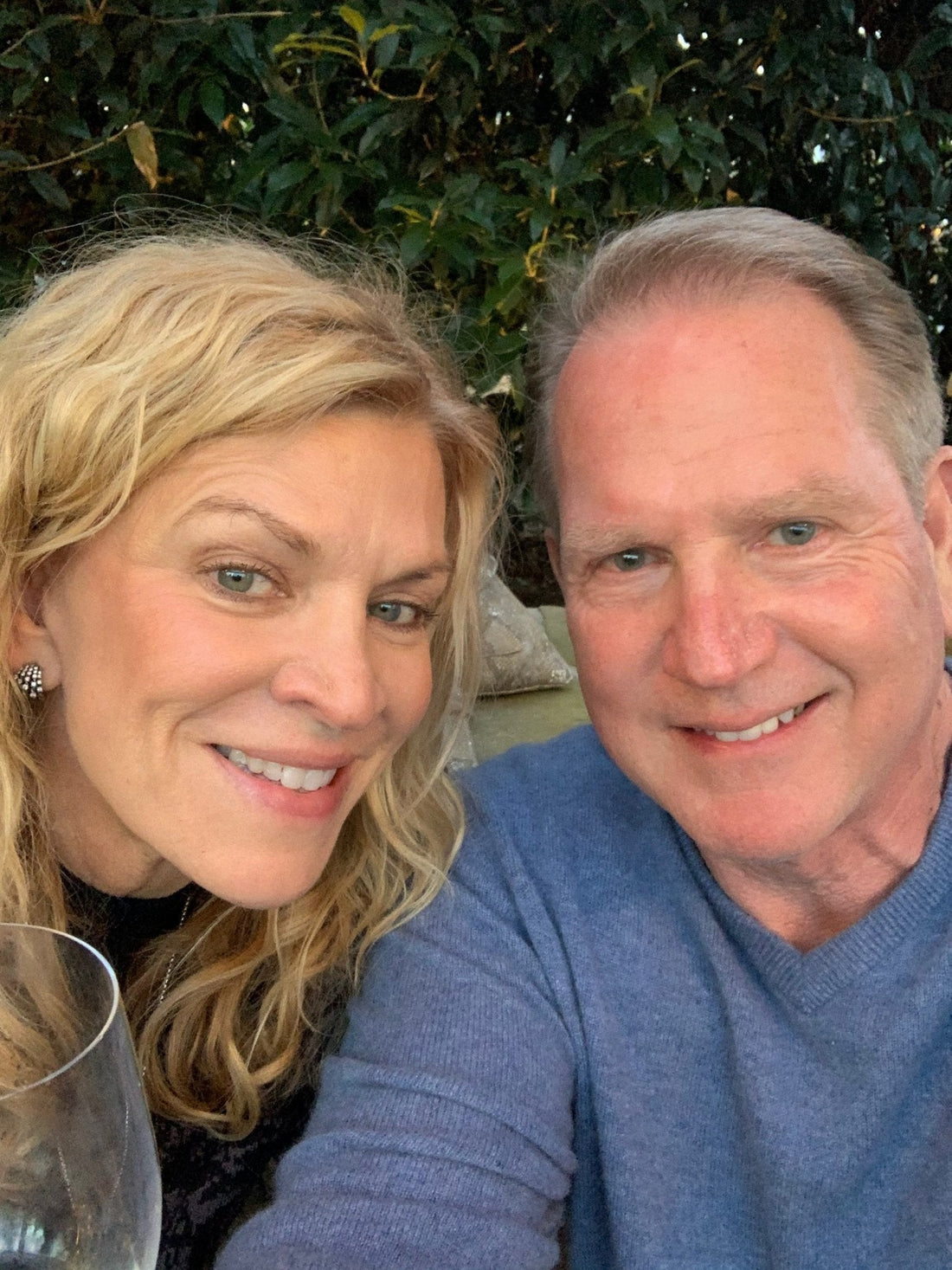 Smiling couple showcasing skincare results.